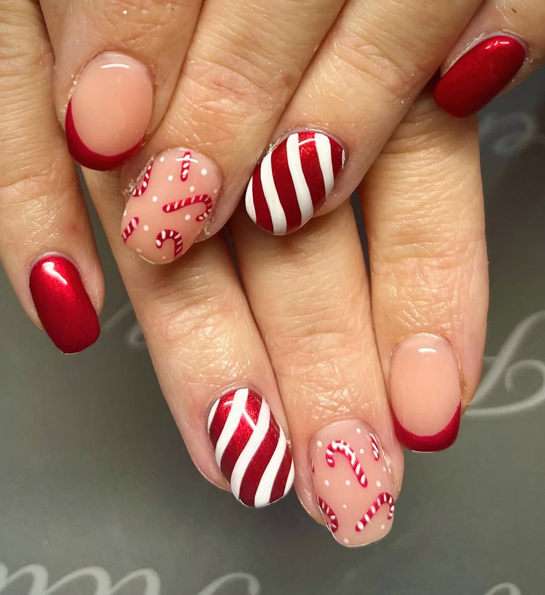 Festive red and white candy cane nail design