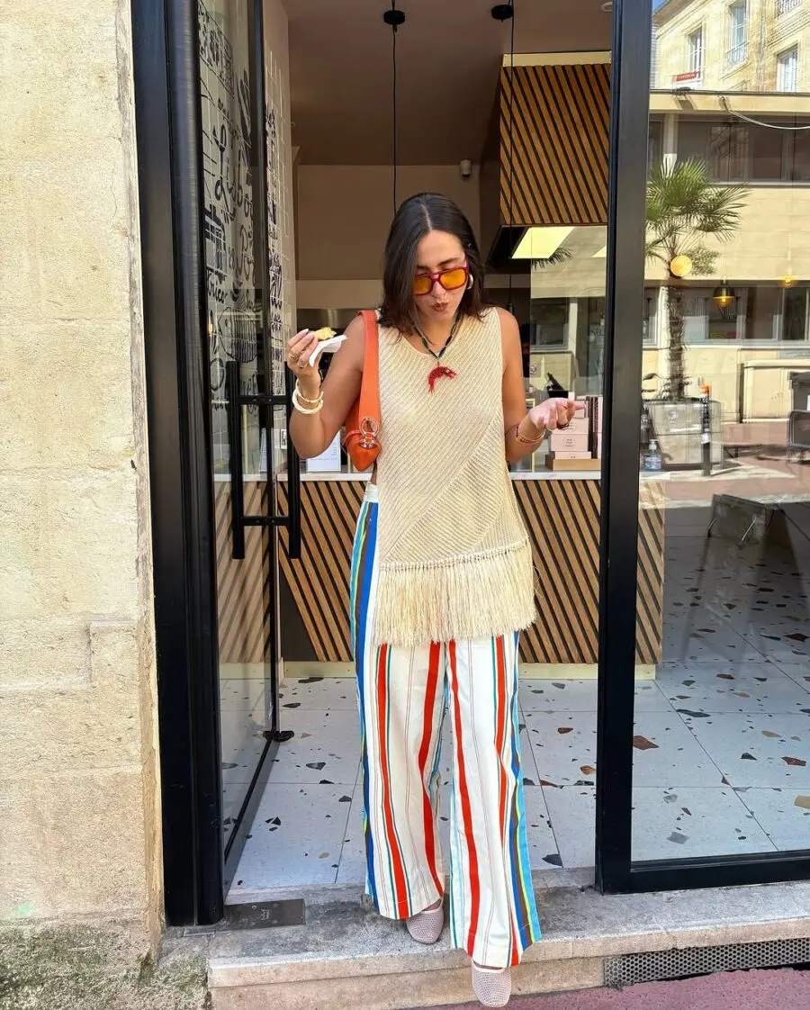 Playful fringed top with vibrant striped pants