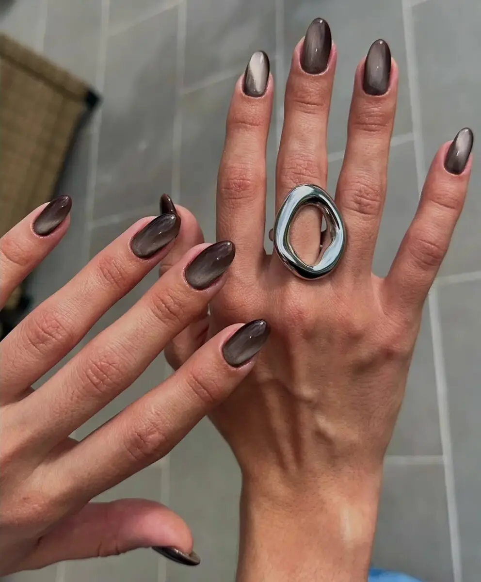 Glossy cat eye nails in rich brown tones