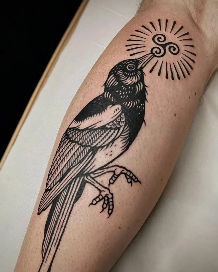 Intricate Celtic bird tattoo with sun symbolism