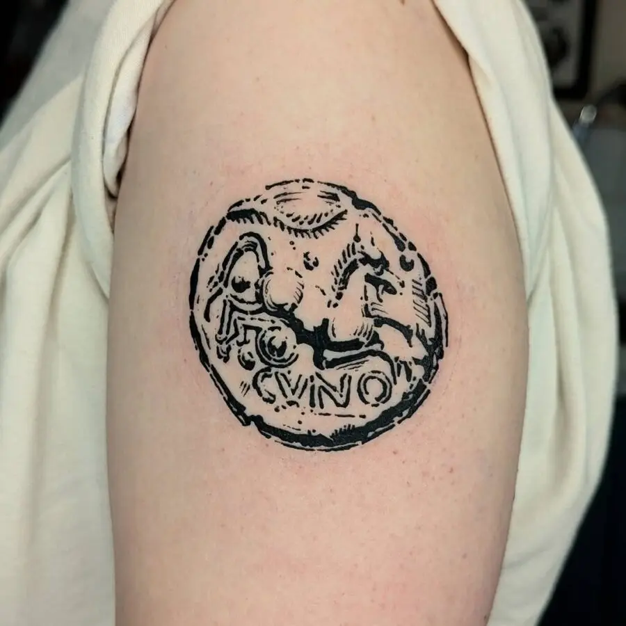 Intricate Celtic coin tattoo design in black ink