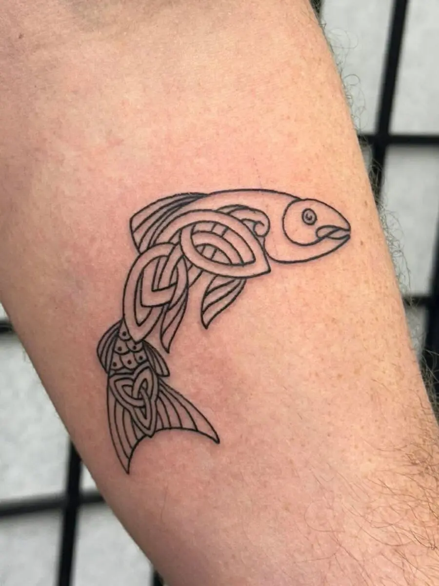 Intricate Celtic fish tattoo design in black ink