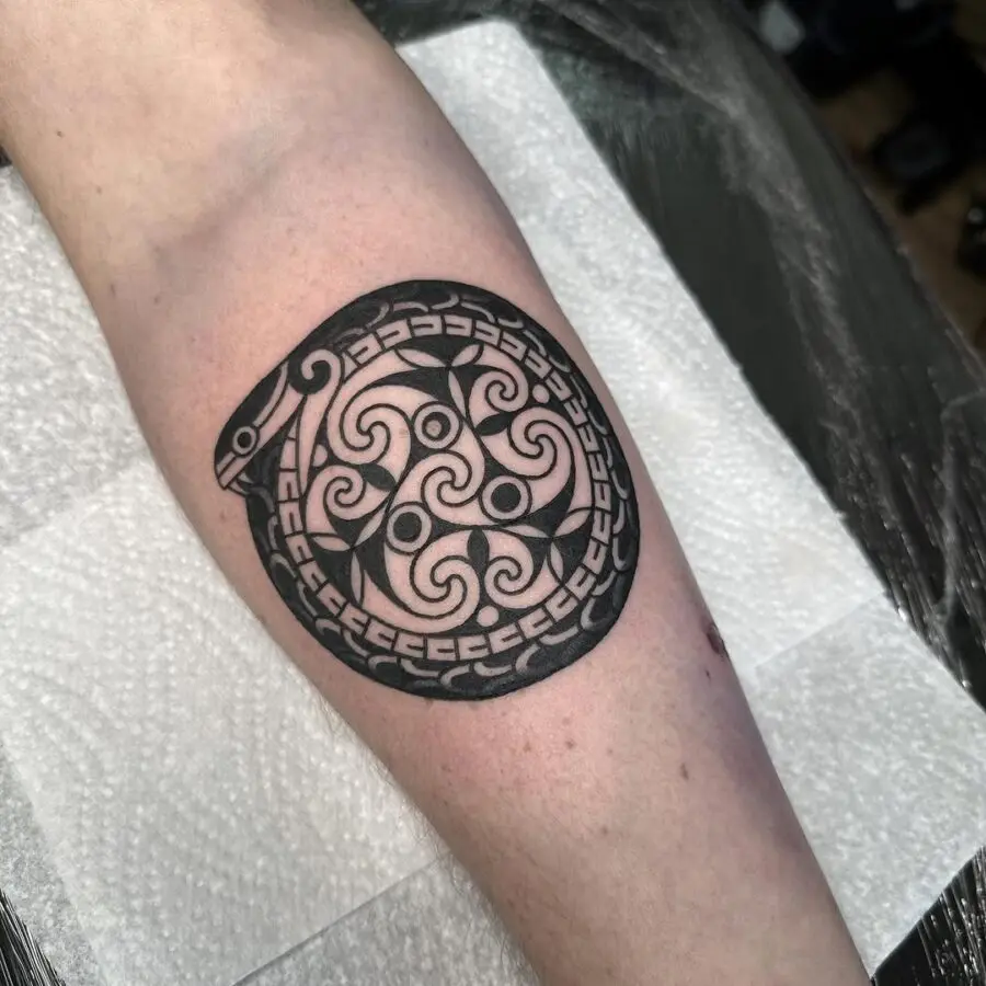Intricate Celtic snake tattoo in circular design