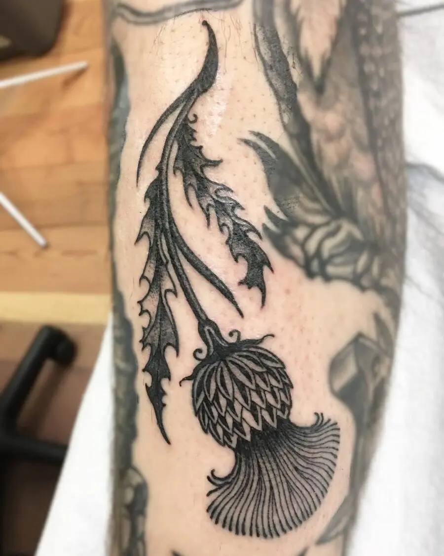 Intricate floral Celtic tattoo design in black ink
