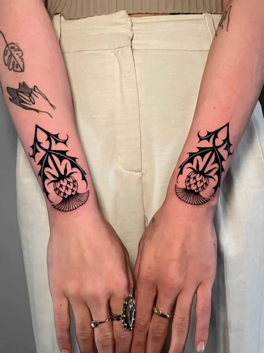 Intricate celtic floral tattoo design on forearms