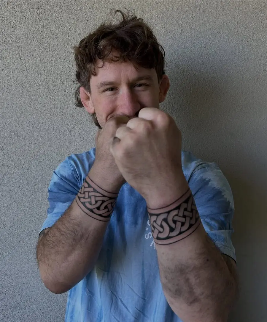 Intricate Celtic knot tattoos on arms