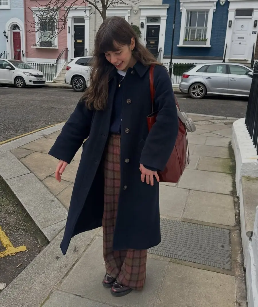 Chic navy coat paired with stylish plaid pants