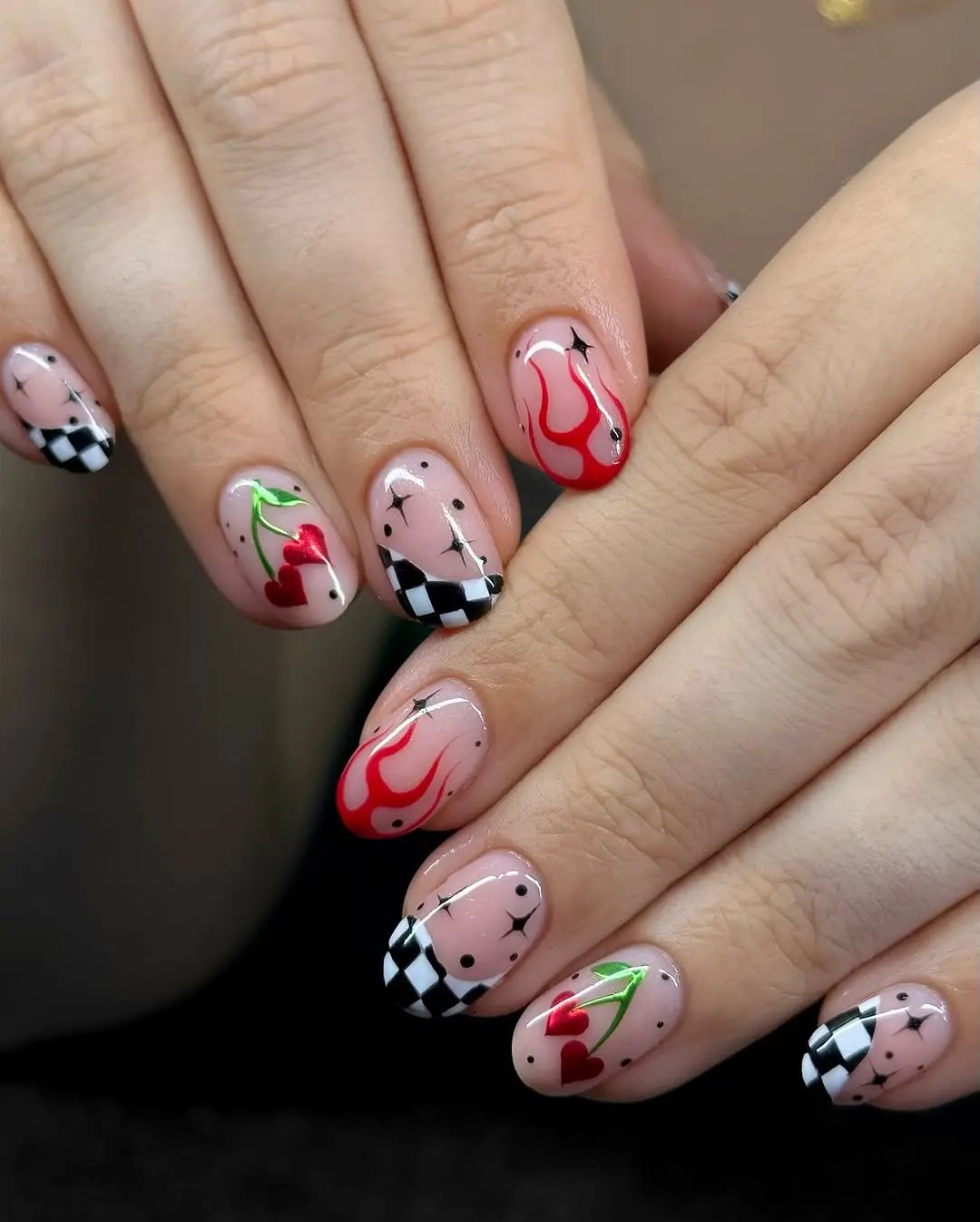 Vibrant cherry nails with playful design elements