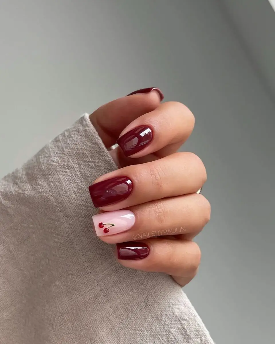 Stylish cherry-inspired nails for chic looks.