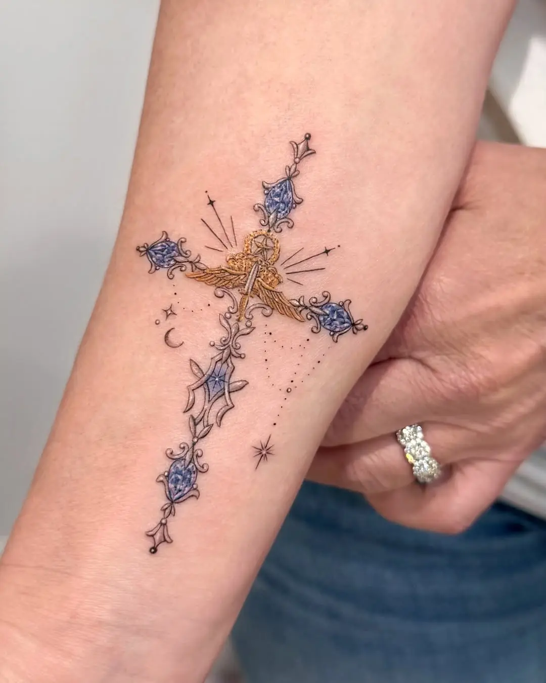 Intricate colorful cross tattoo design inspiration