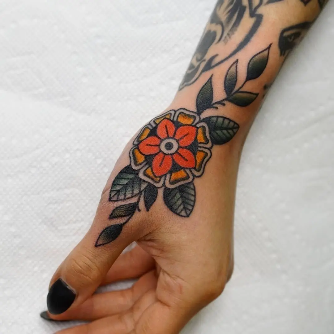 Vibrant floral side hand tattoo design