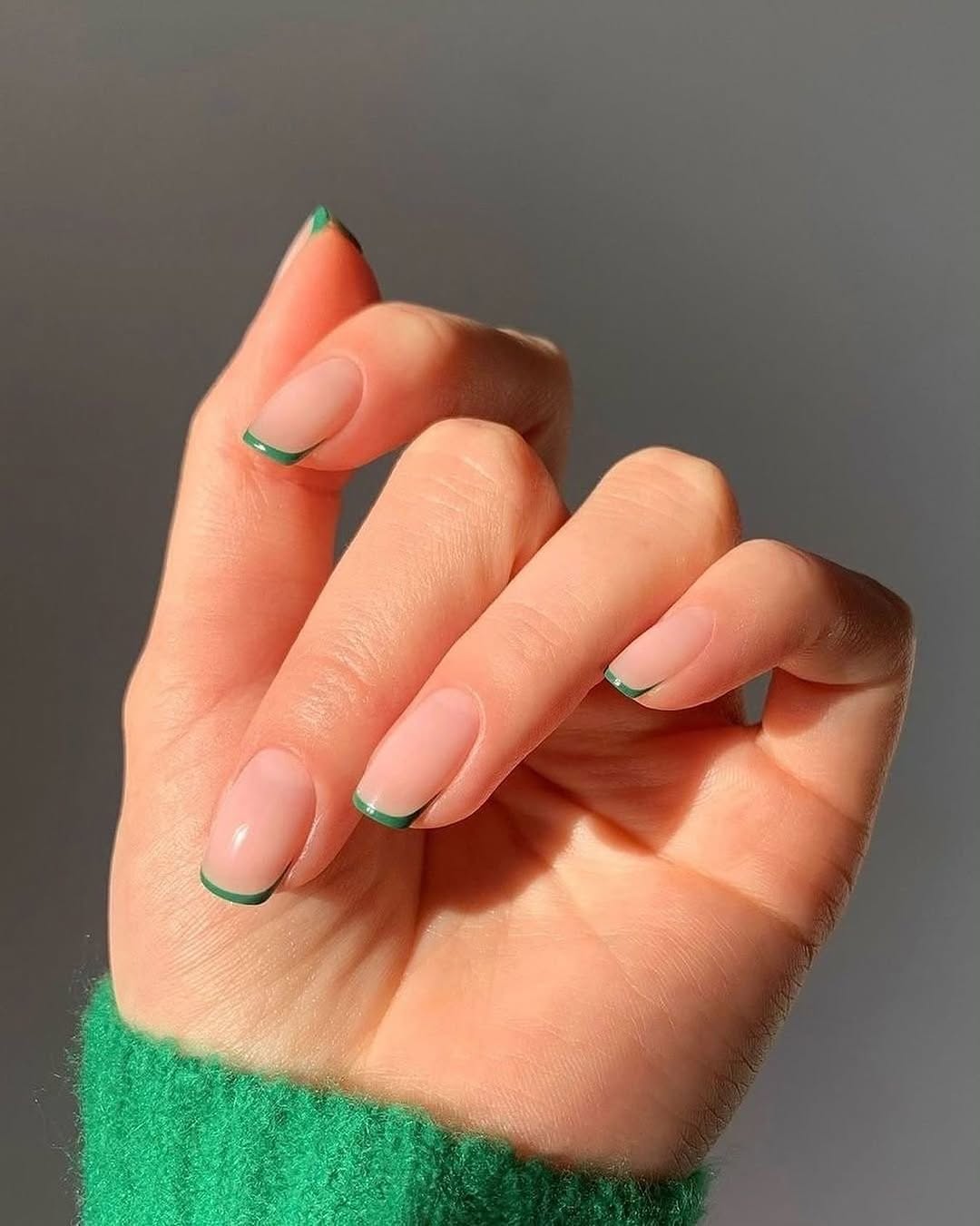 Vibrant green tips on natural nails