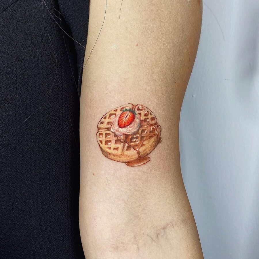 Vibrant waffle tattoo with strawberry topping