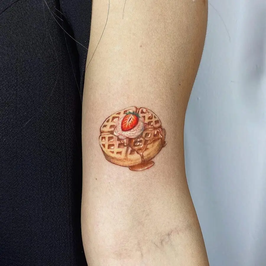 Vibrant waffle tattoo with strawberry topping