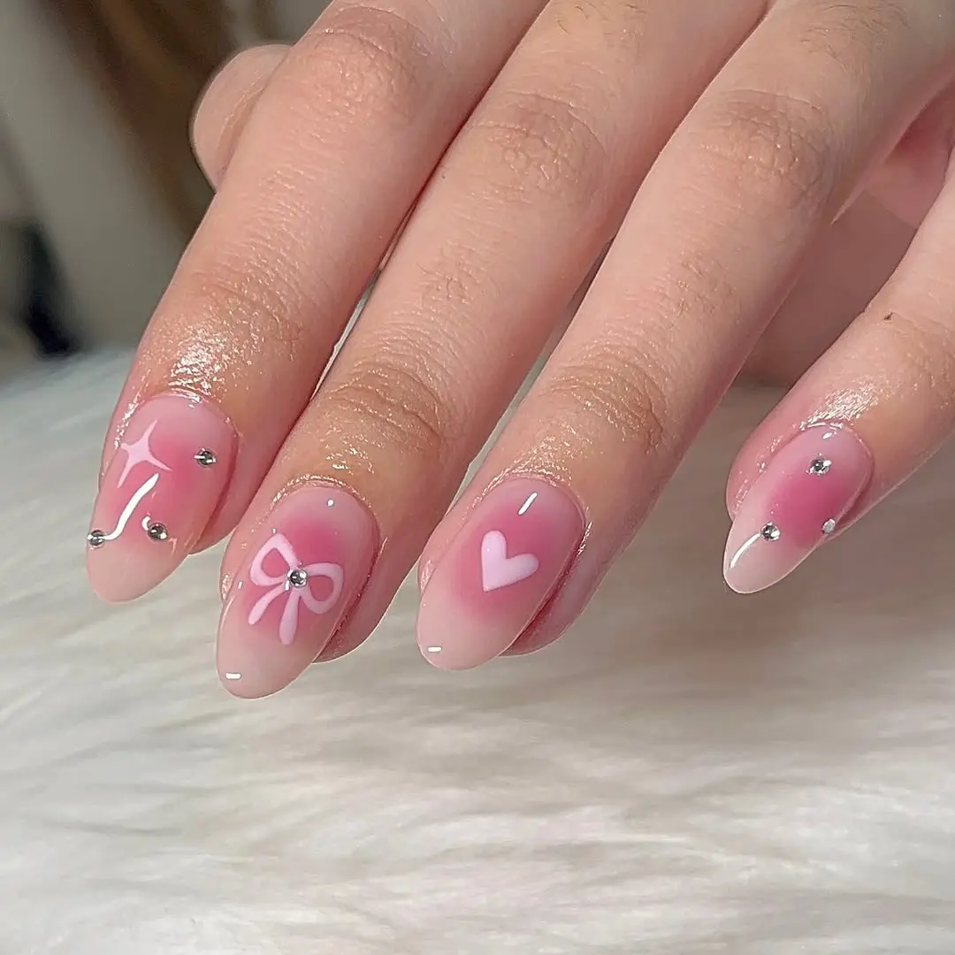 Charming pink ombre coquette nails with embellishments