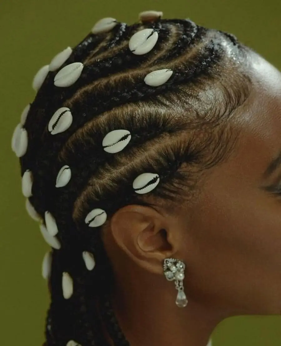 Stunning cornrows adorned with shell accessories.