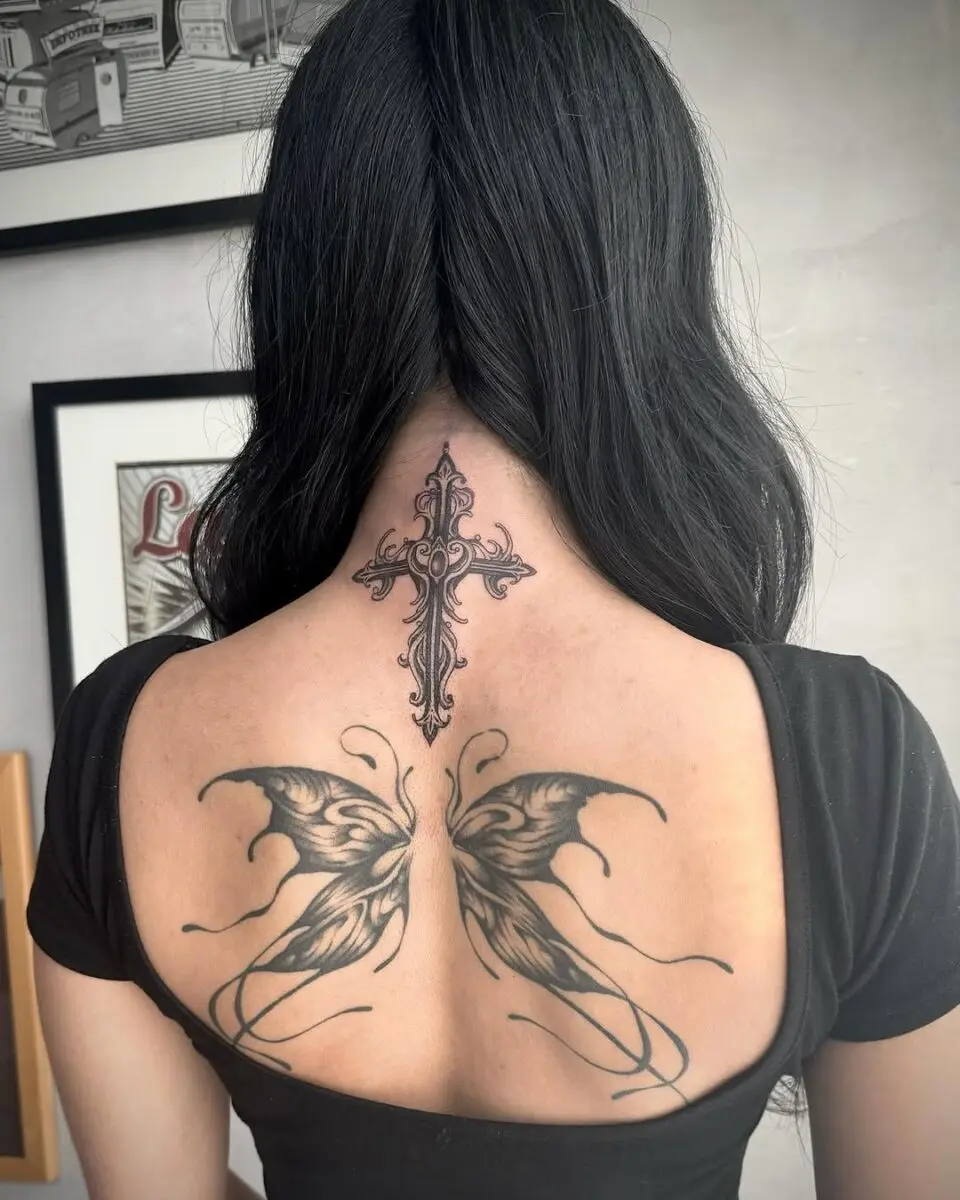 Elegant cross tattoo with butterfly wings