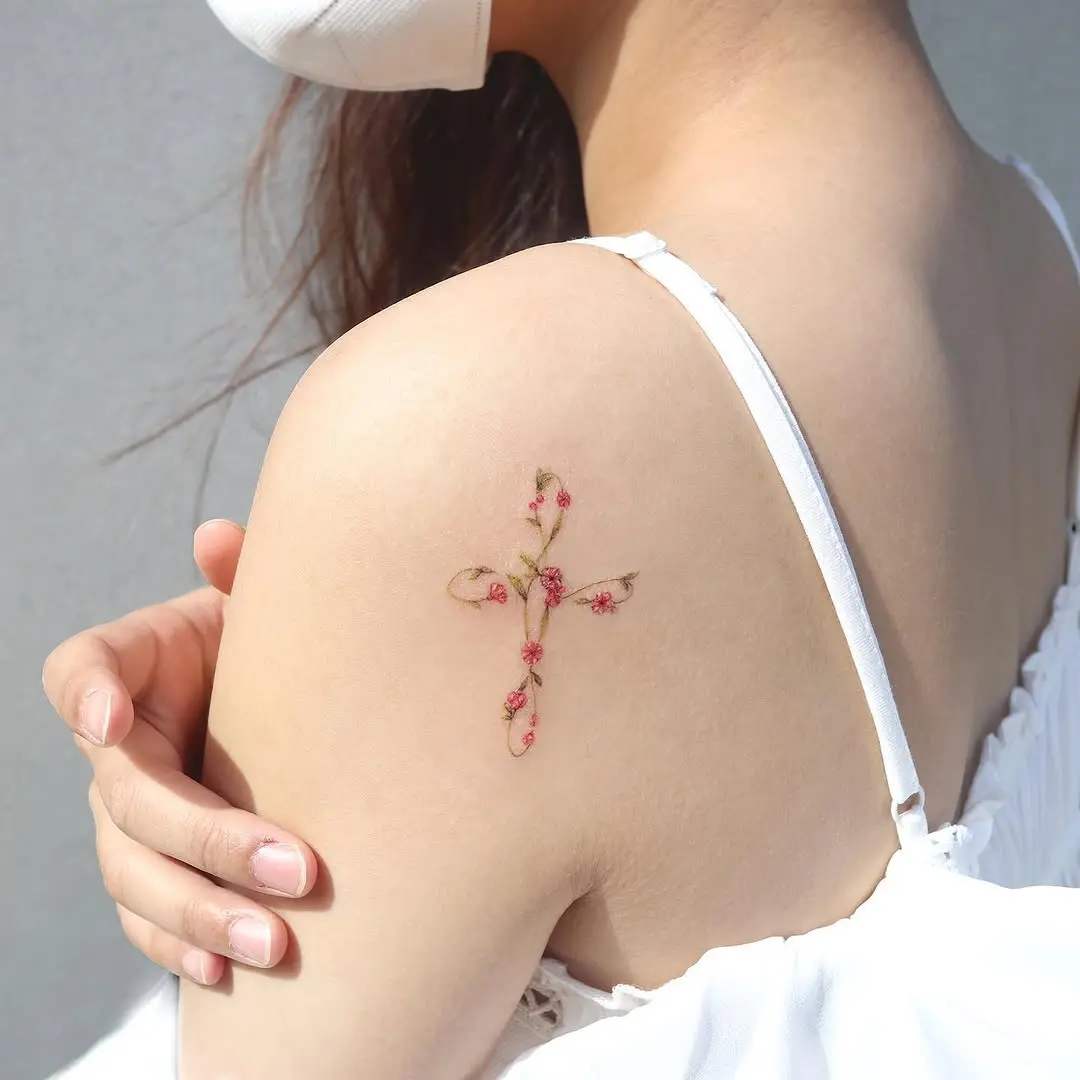 Delicate Cross Tattoo with Floral Accents