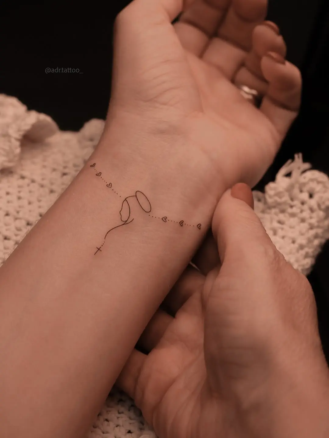 Minimalist cross tattoo with enchanting balloon design
