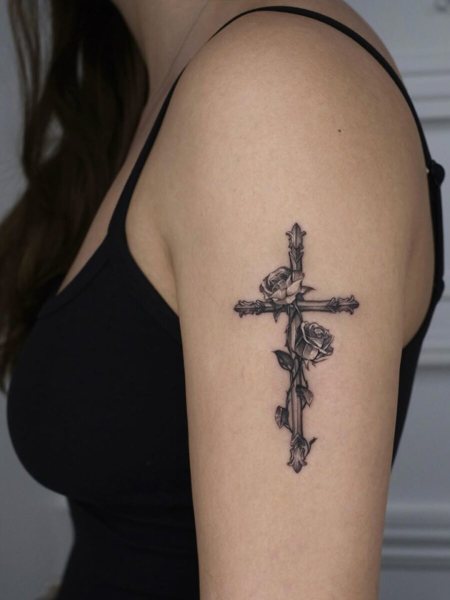 Elegant cross tattoo with floral accents