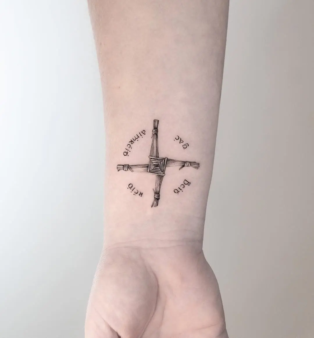 Stylish woven cross tattoo on the arm
