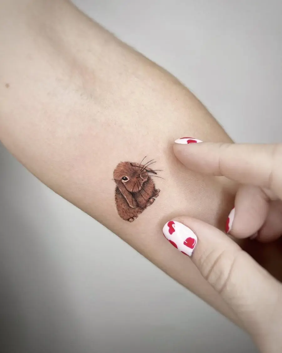 Charming brown rabbit tattoo on forearm