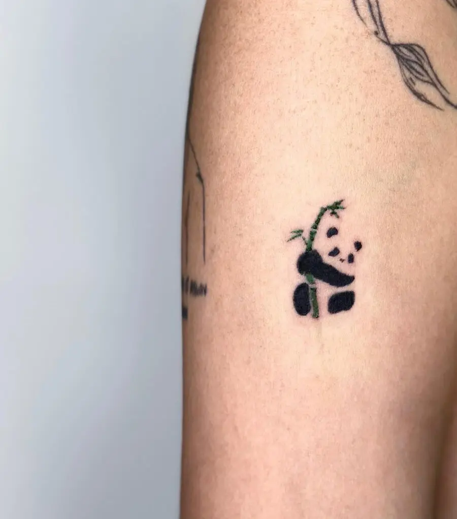 Adorable panda tattoo with playful bamboo details