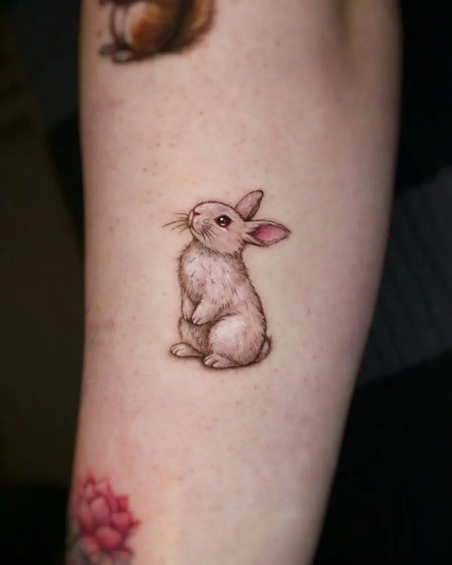 Adorable realistic rabbit tattoo on arm