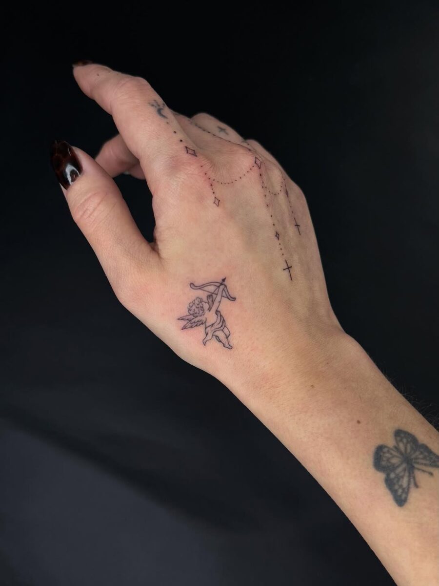 Elegant floral patterns grace this side hand tattoo