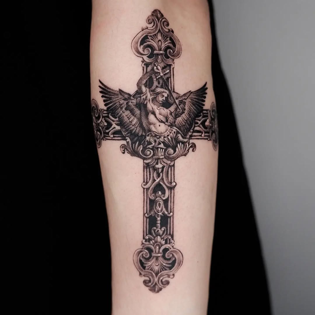 Elegant cross tattoo with detailed wing design
