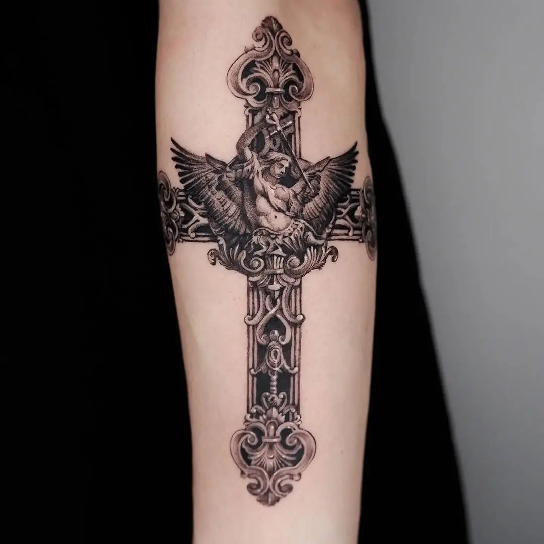 Elegant cross tattoo with detailed wing design