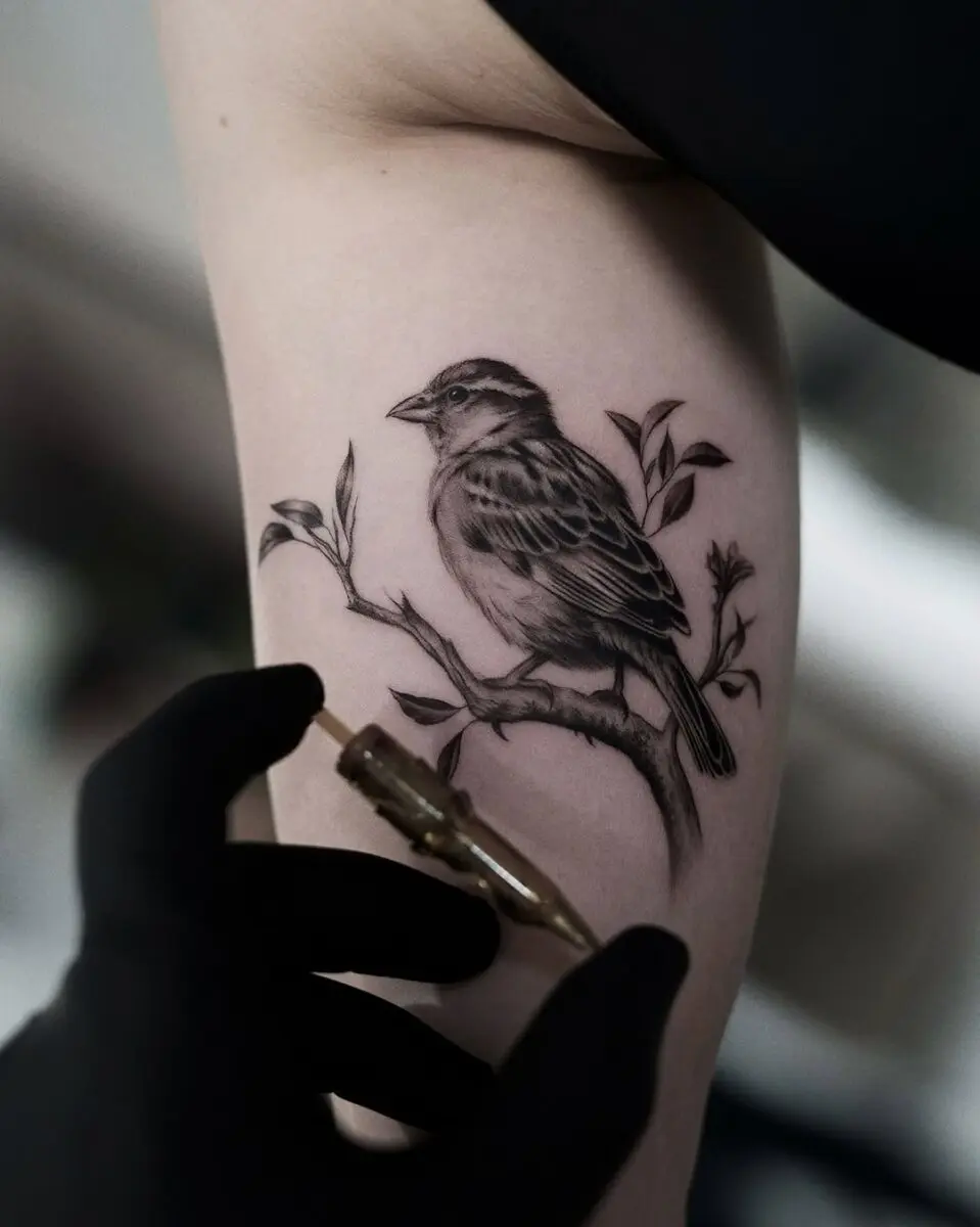 Intricate sparrow tattoo capturing natural beauty.