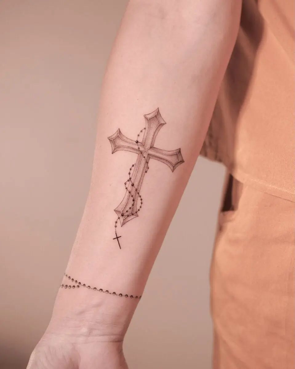 A beautifully detailed cross tattoo design