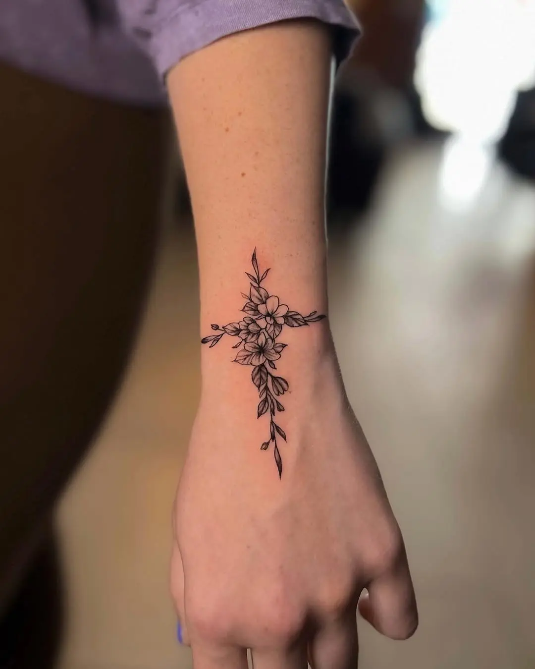 Elegant floral cross tattoo design