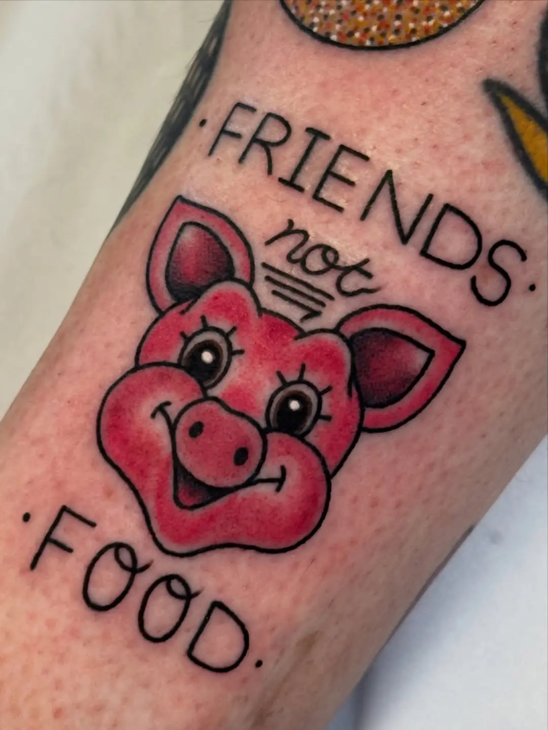 Vibrant vegan tattoo promoting animal welfare