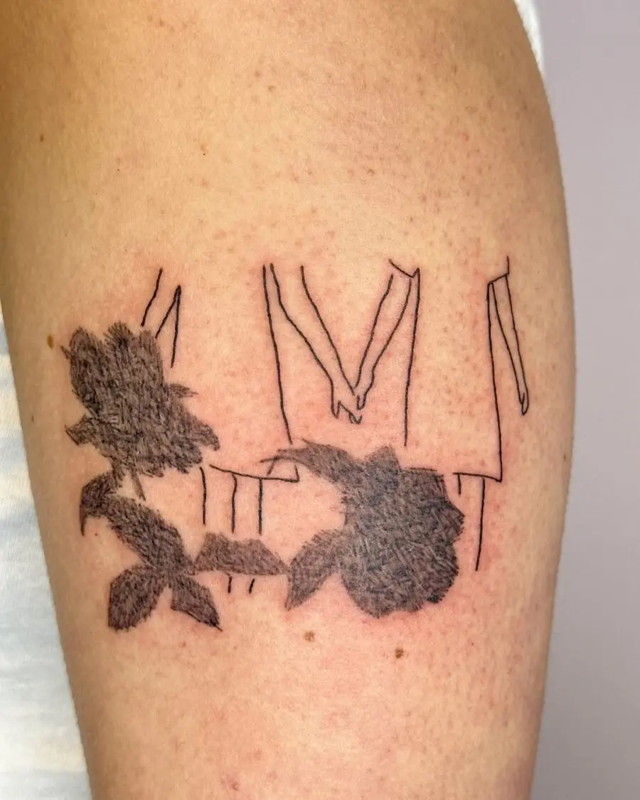 Minimalist tattoo of hands holding roses