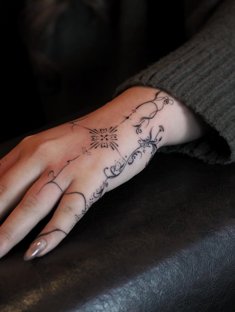 Elegant side hand tattoo showcases intricate artistry