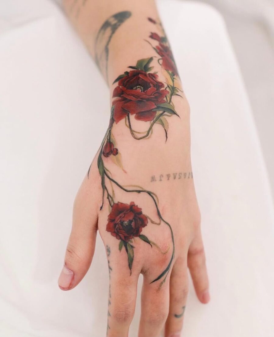 Elegant red rose hand tattoo design inspiration