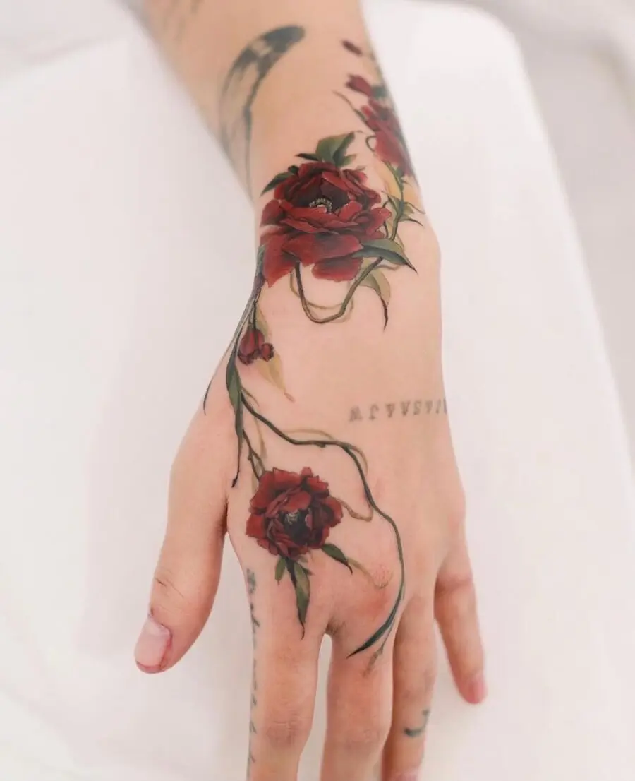Elegant red rose hand tattoo design inspiration