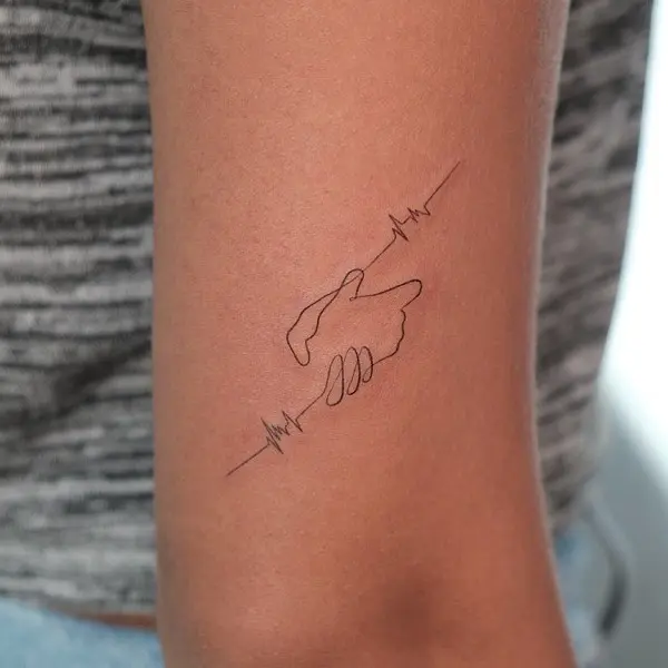 Meaningful heartbeat and hand connection tattoo