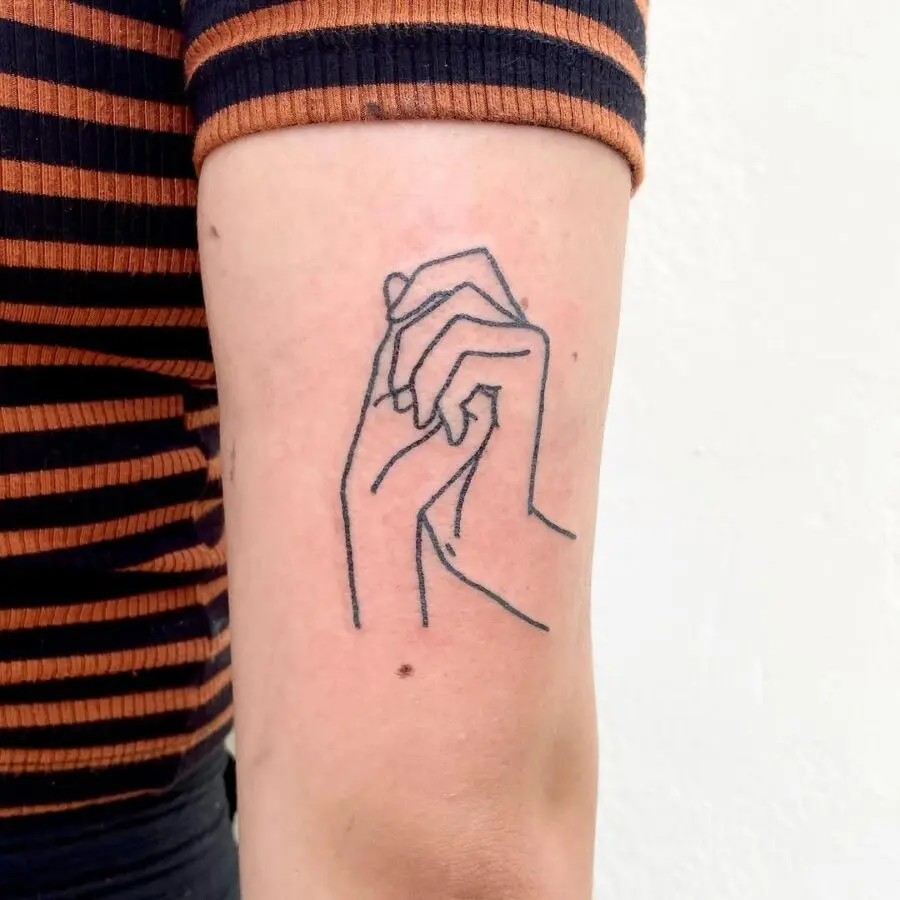 Minimalist hands intertwined tattoo design