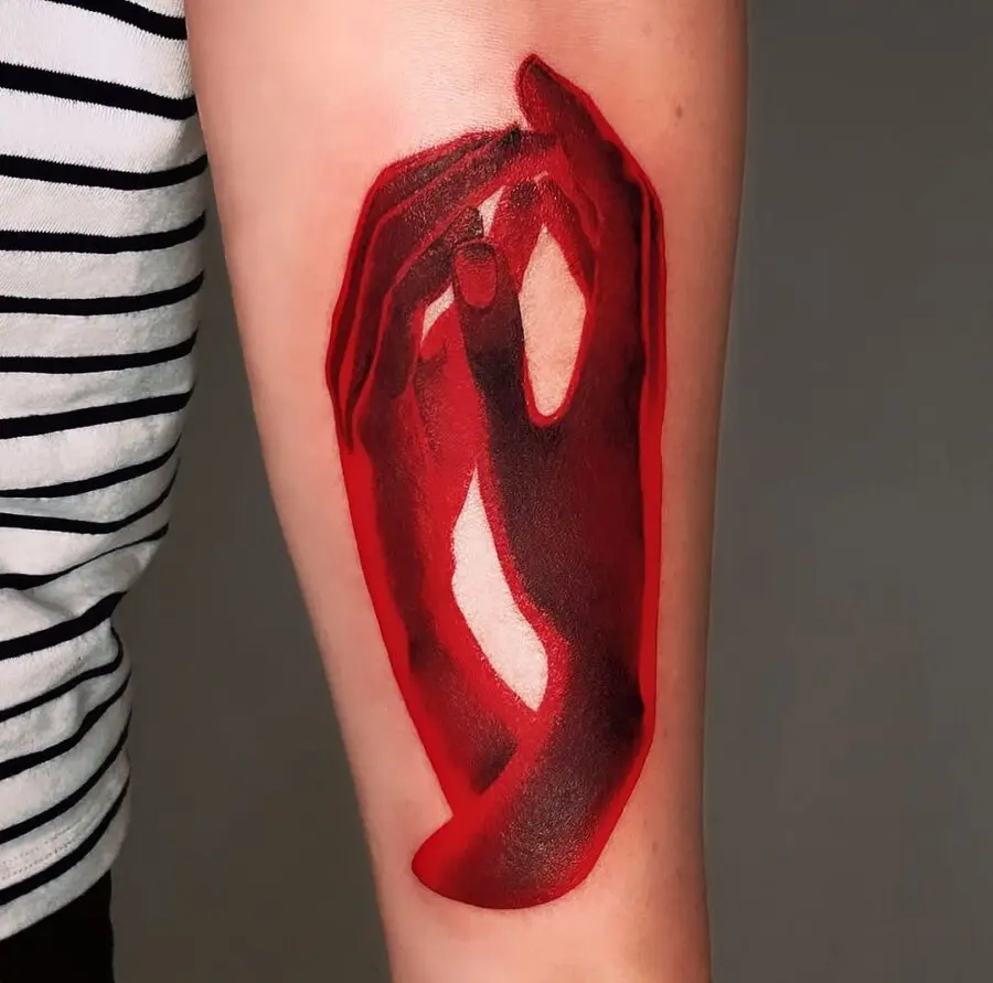 Red-hued hands intertwined tattoo design