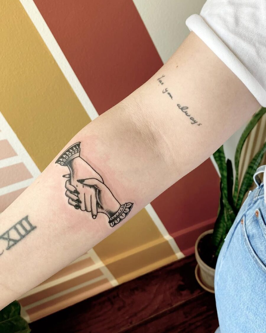Elegant Holding Hands Tattoo on Forearm