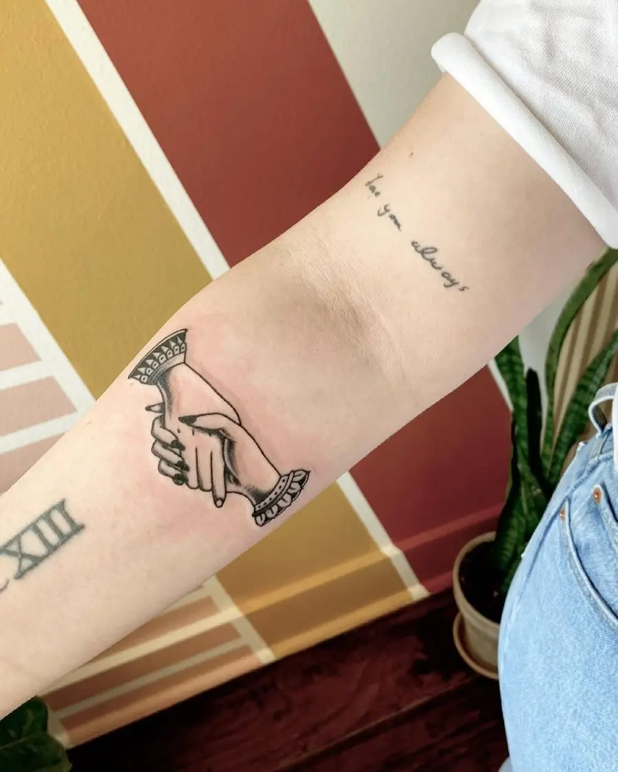 Elegant Holding Hands Tattoo on Forearm
