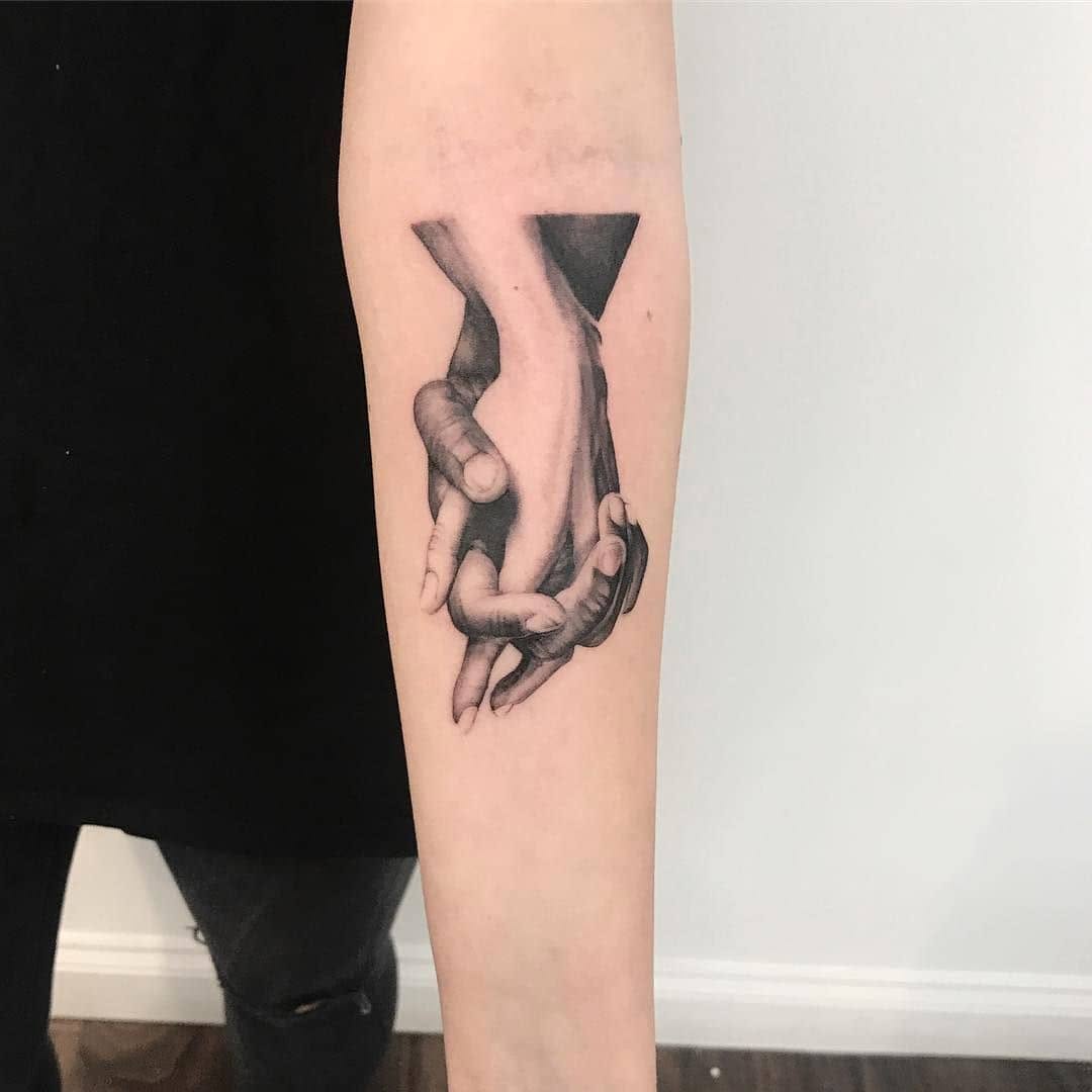 Elegant black and gray holding hands tattoo