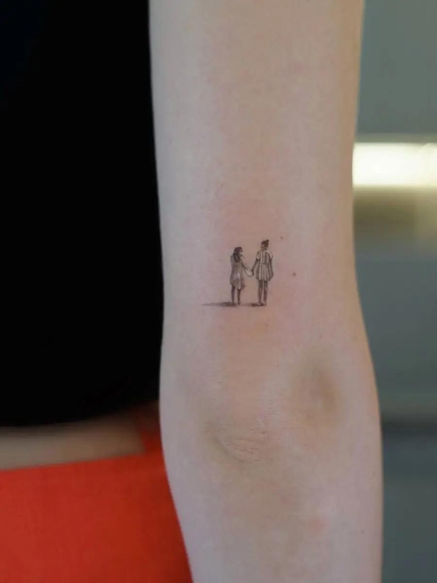 Minimalist Holding Hands Tattoo Symbolizing Love