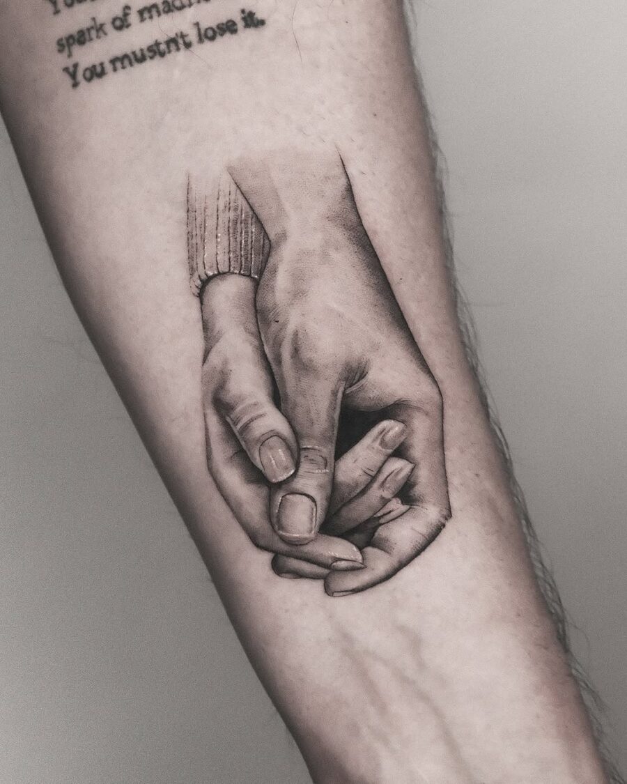 Realistic holding hands tattoo design inspiration