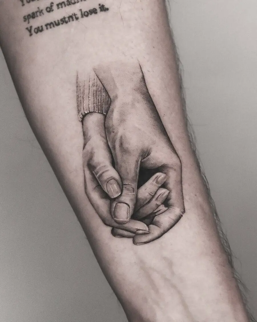 Realistic holding hands tattoo design inspiration