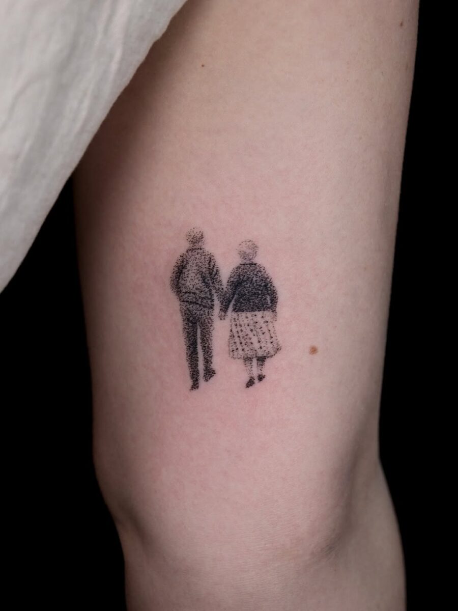 Endearing couple silhouette holding hands tattoo