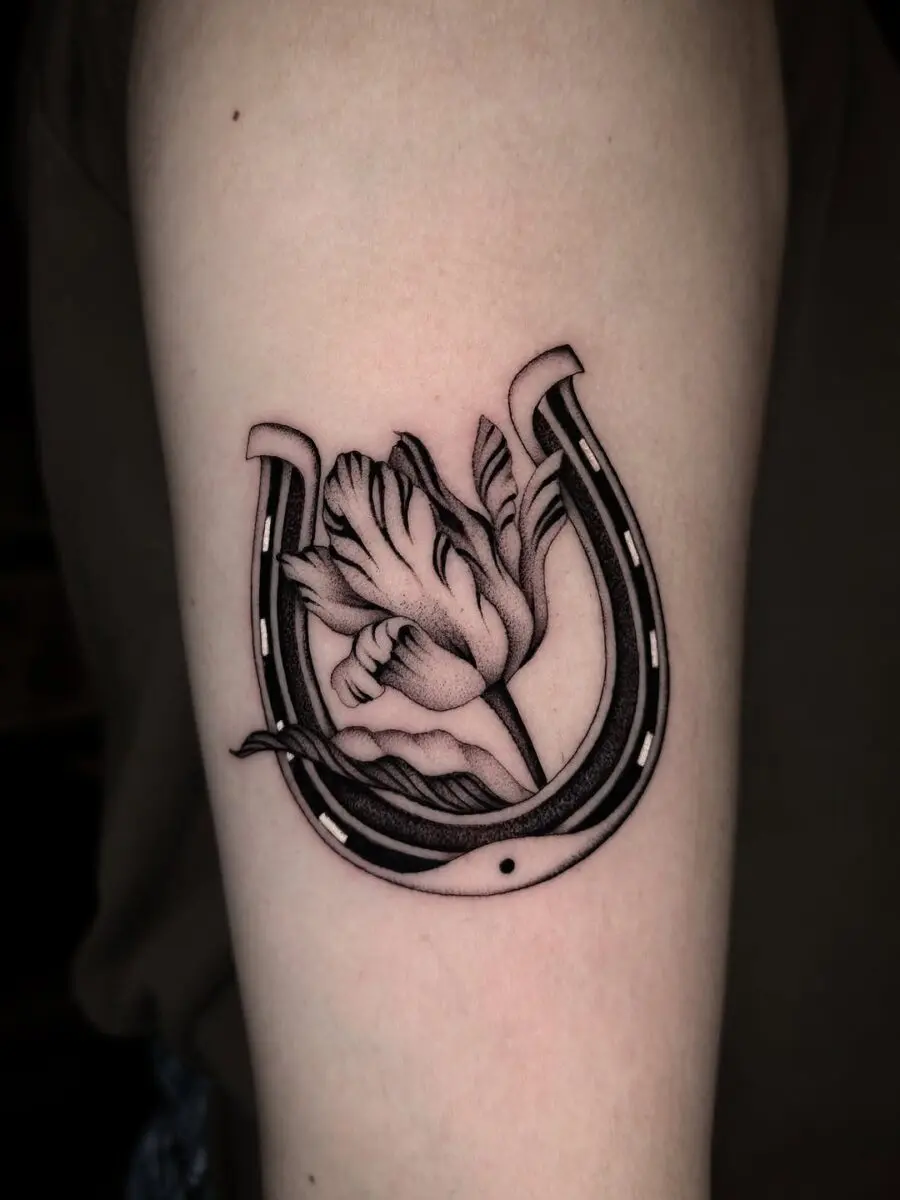 Elegant horseshoe tattoo with floral design